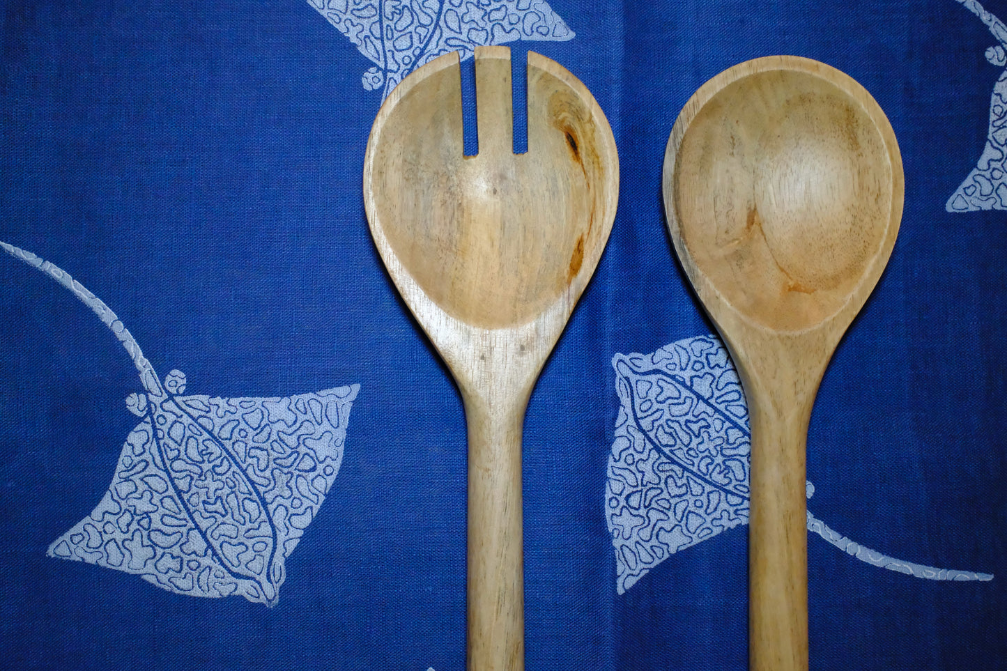&BEYOND Eagle Ray Blues linen napkin styled with a plate and silverware.