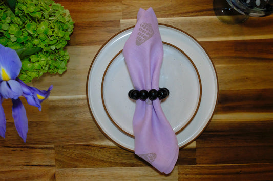 &BEYOND Hebrew Shell linen napkin styled on a white plate.