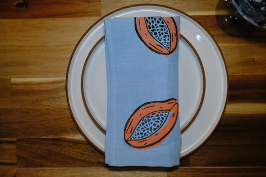 &BEYOND Papaya Dream linen napkin placed on a decorative plate.