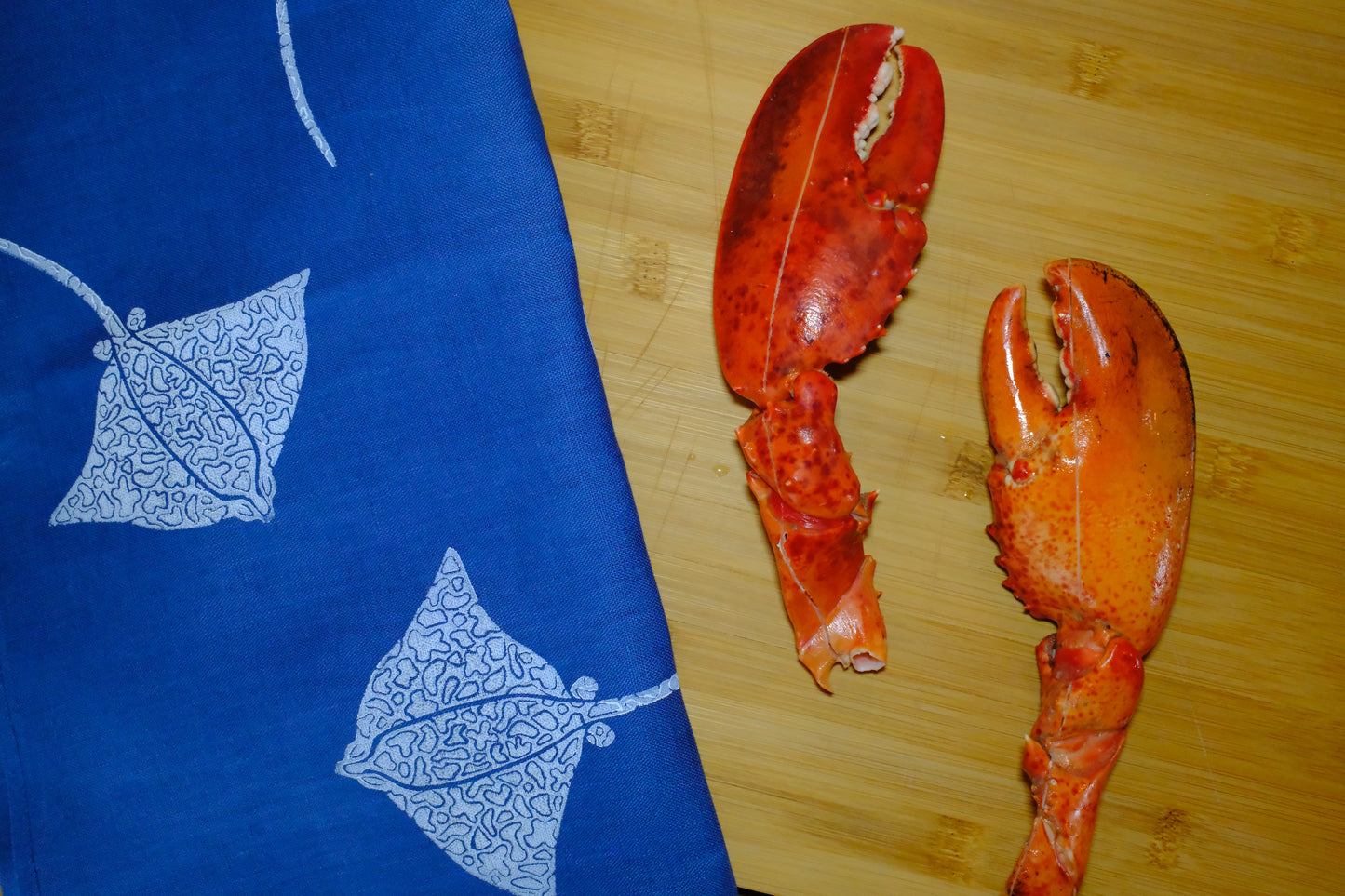 &BEYOND Eagle Ray Blues napkin displayed beside a dish of food.
