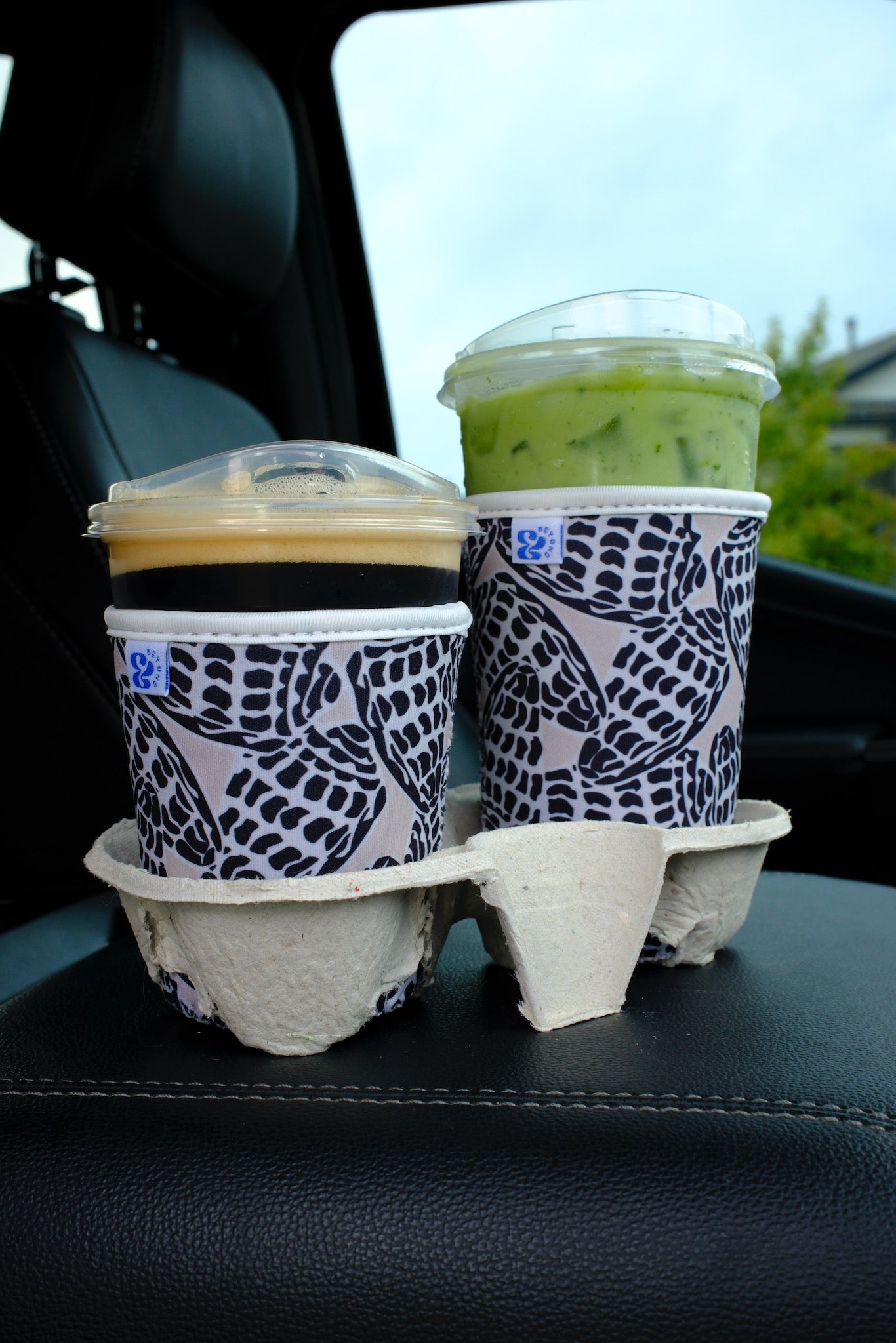 &BEYOND Hebrew Shell iced coffee coozies in small and medium sizes shown together, demonstrating the size difference on cold drink cups.