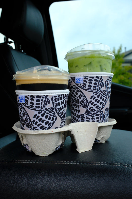 &BEYOND Hebrew Shell iced coffee coozies in small and medium sizes shown together, demonstrating the size difference on cold drink cups.