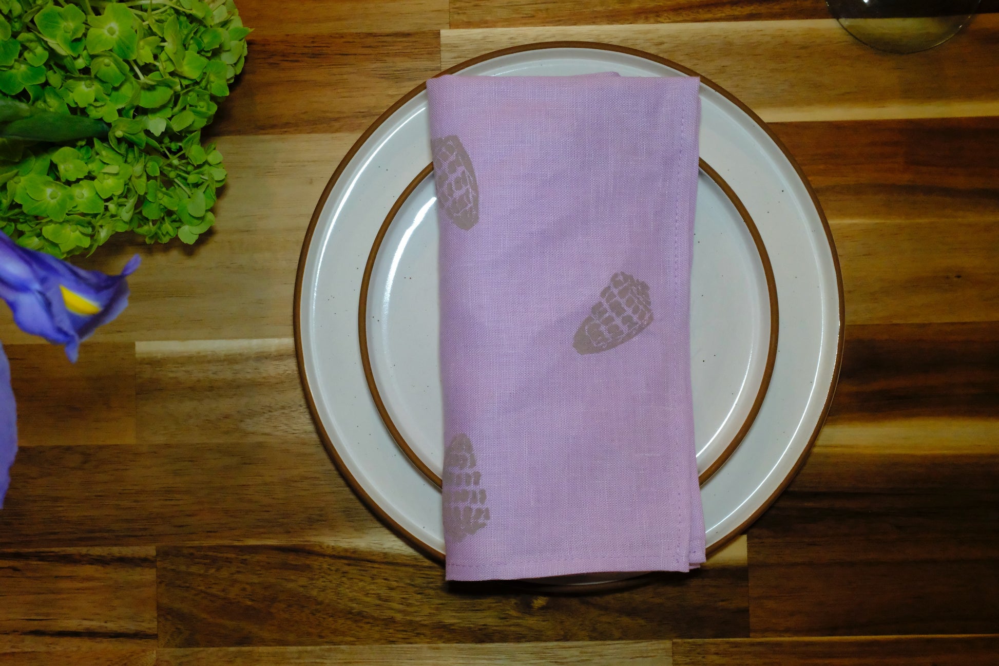 Stacked folded view of the &BEYOND Hebrew Shell linen napkins.