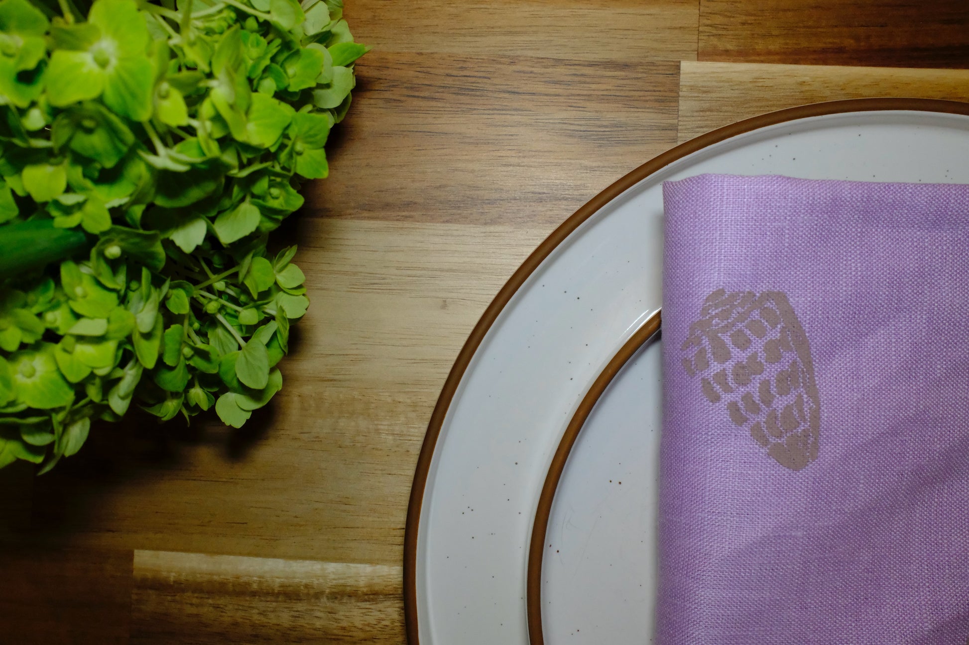 &BEYOND Hebrew Shell linen napkins displayed neatly on a dining table.