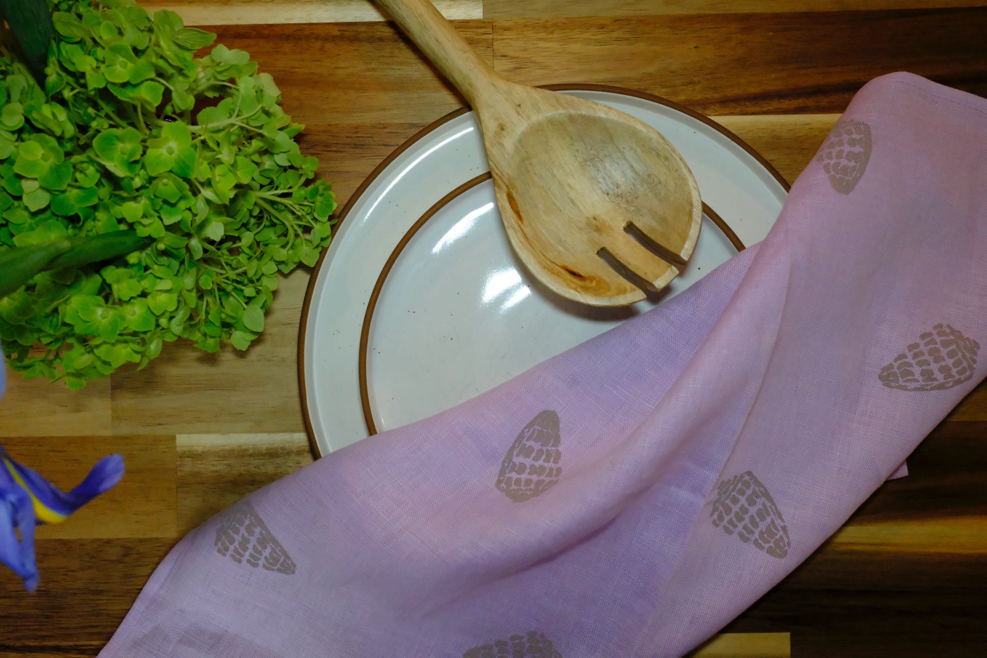 Lifestyle shot of &BEYOND Hebrew Shell napkins in a soft dining environment.