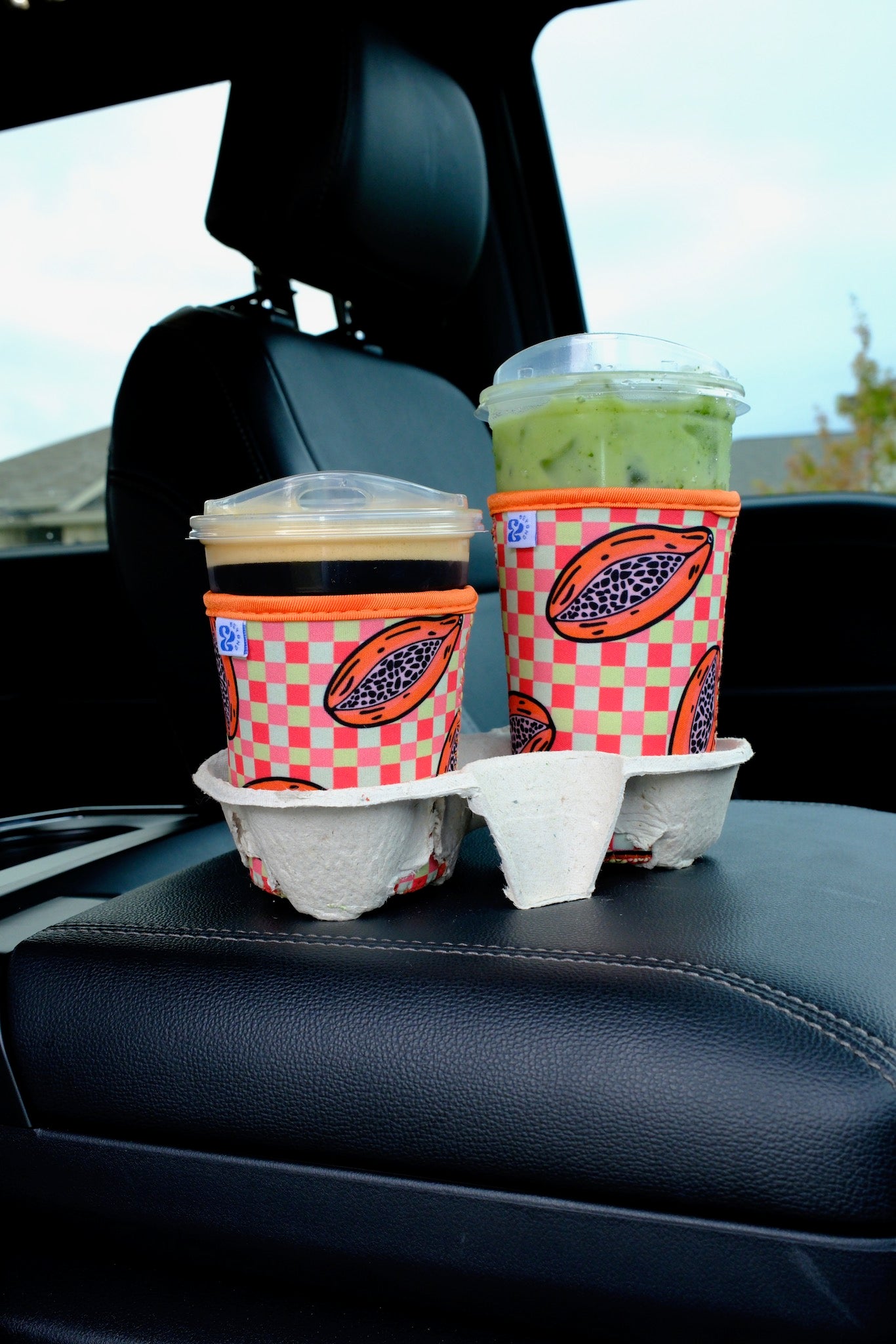 &BEYOND Papaya Dream coozie styled beside fresh fruit for a bright summer look.