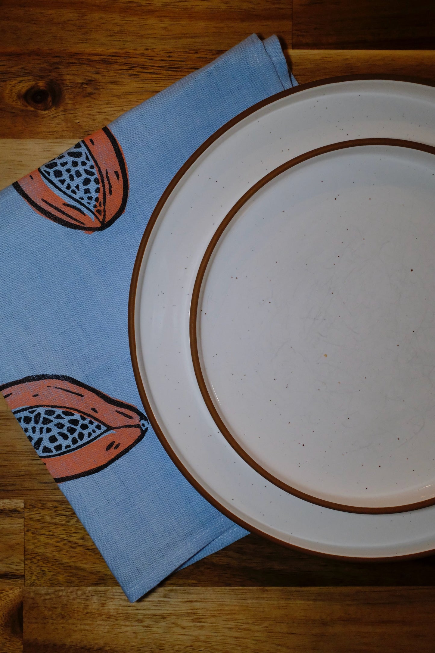 &BEYOND Papaya Dream linen napkins displayed on a dining table.