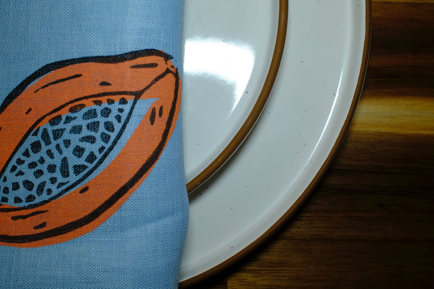 &BEYOND Papaya Dream napkin styled beside fresh food for a colorful look.