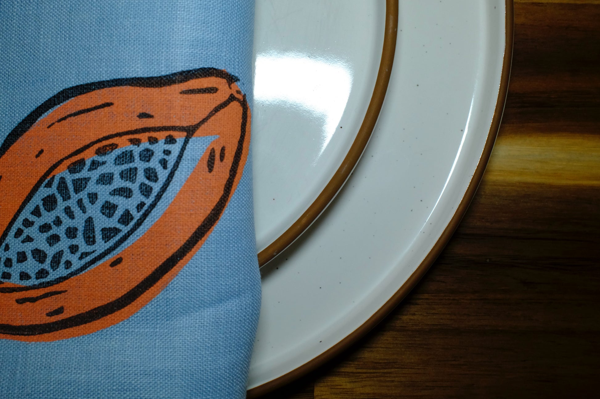 &BEYOND Papaya Dream napkin styled beside fresh food for a colorful look.