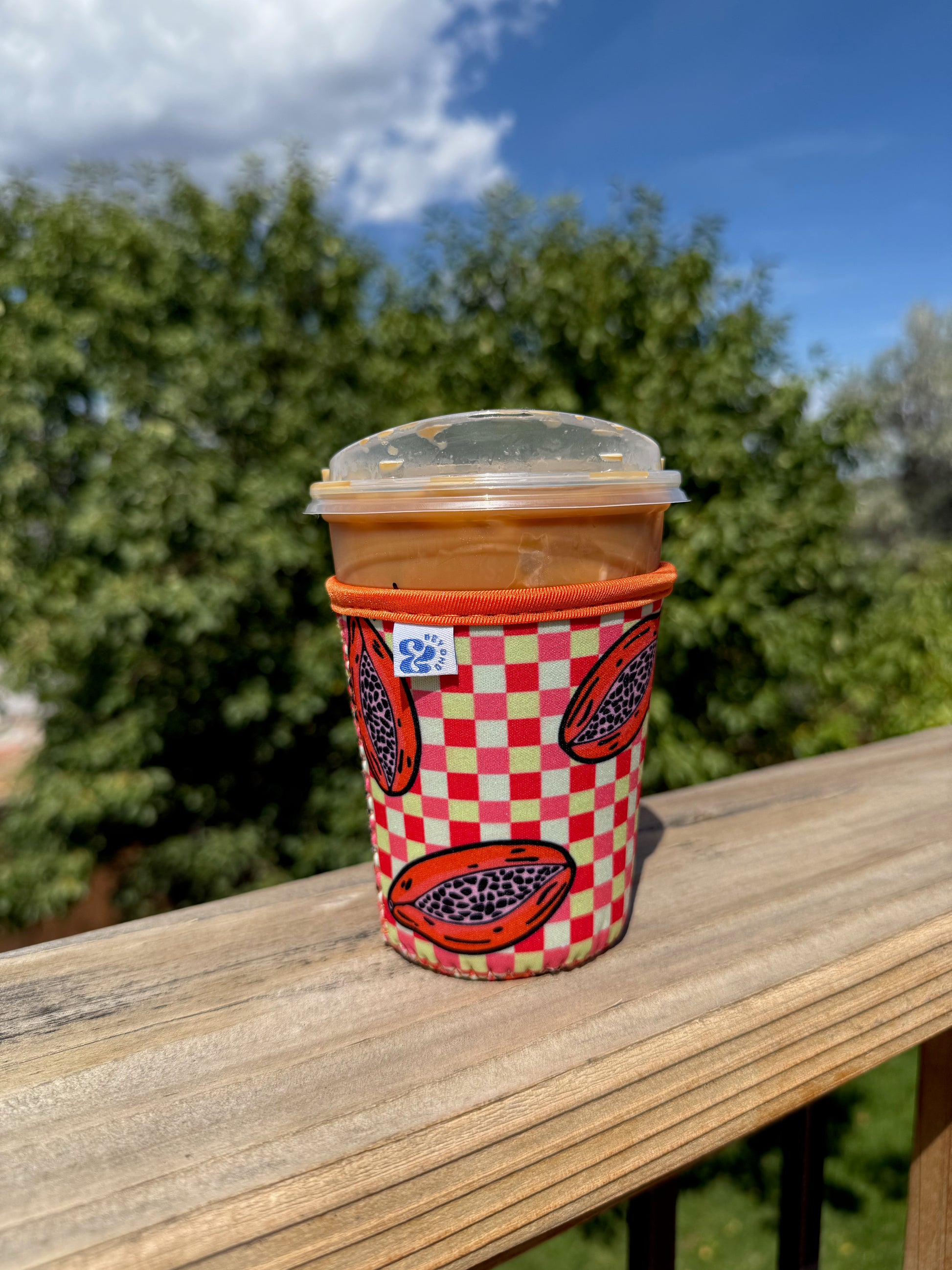 &BEYOND Papaya Dream coozie styled beside fresh fruit for a bright summer look