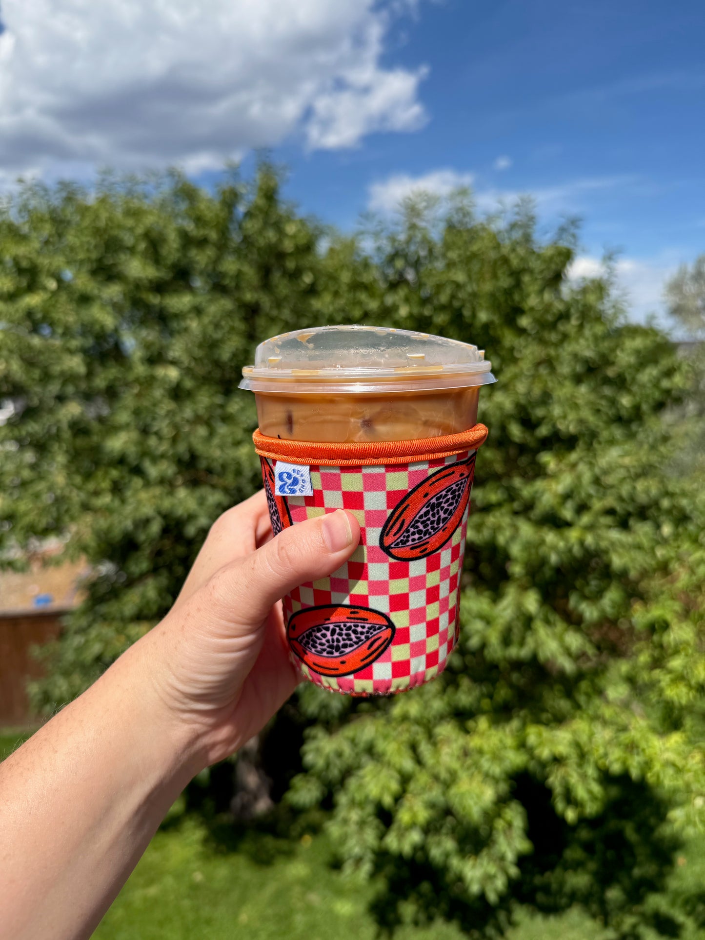 Close-up of the &BEYOND Papaya Dream coozie, showing the vibrant print.